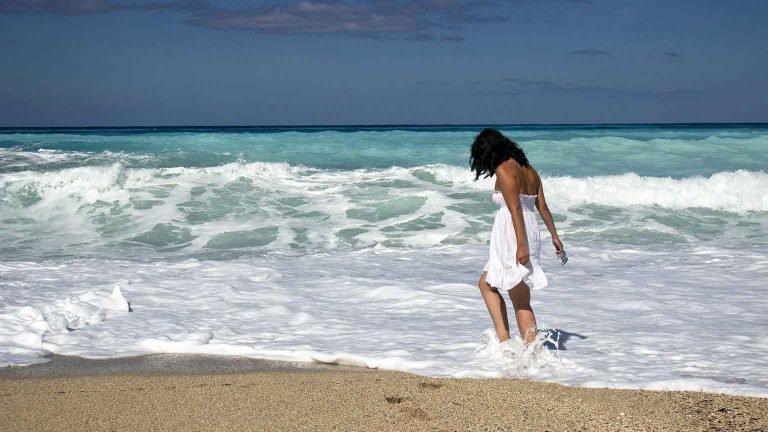 healthy living woman walking on the beach