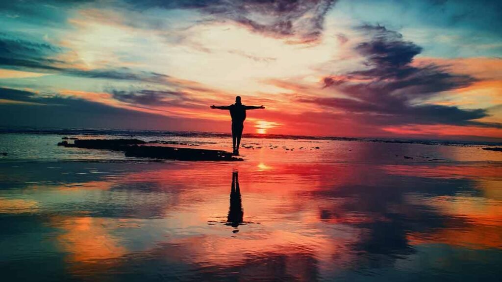 a person experiencing freedom on a beach