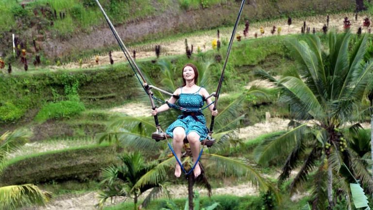 a woman having a ball on a swing - fun idioms