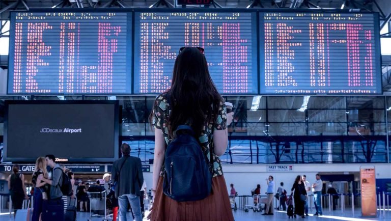 woman looking at an airport screen