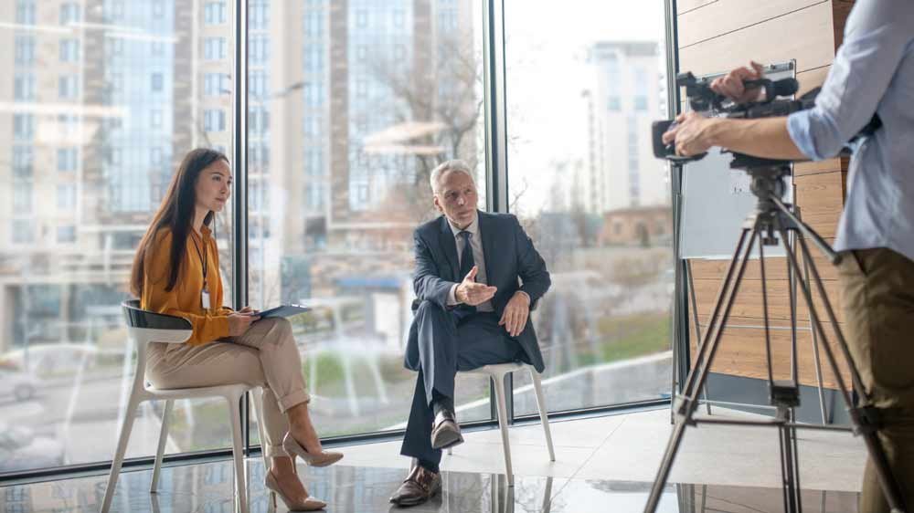 2 people being interviewed on camera