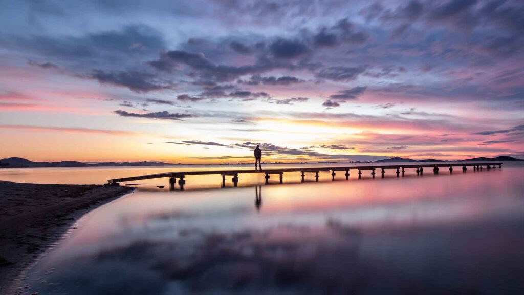 a man alone on a pier