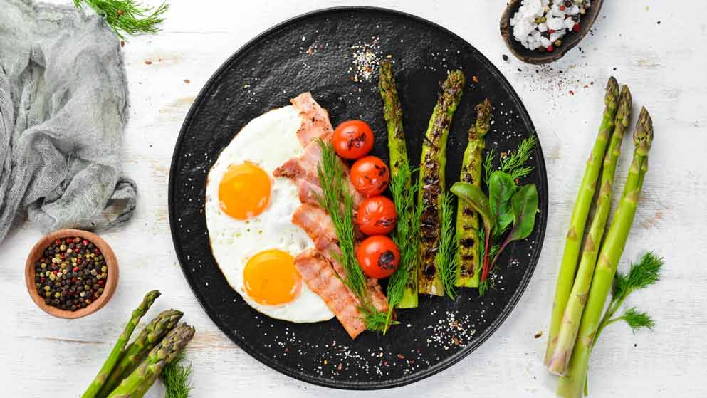 a fried breakfast with bacon and eggs