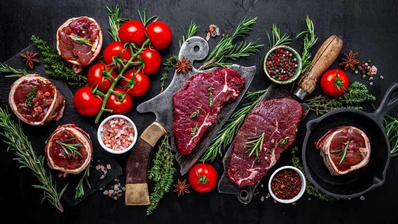 a table of meat and herbs