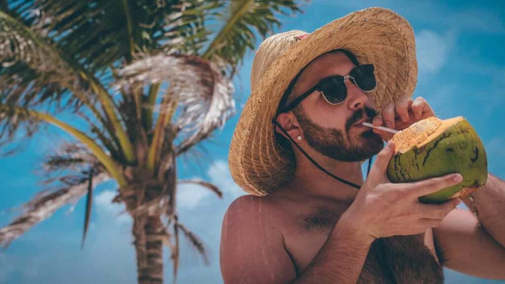 maan dring a coconut with a straw