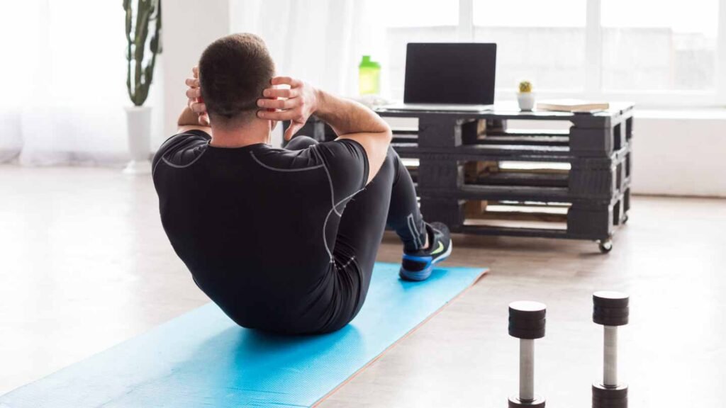 a man exercising doing sit-ups at home