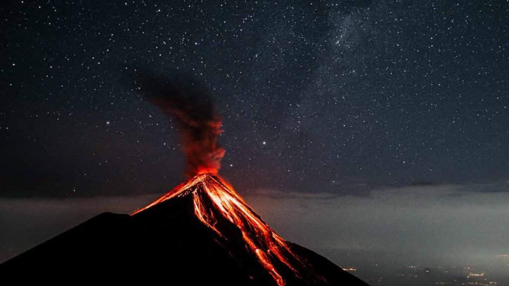a volcano erupting at night