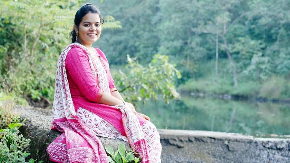 a happy person sitting by a lake