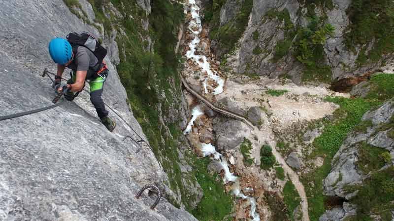 a person abseiling a cliff with safety gear