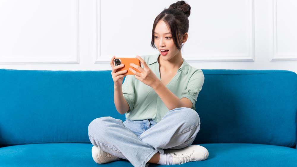 a girl entertaining herself on a mobile phone.