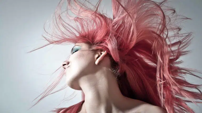 a girl tossing her pink hair