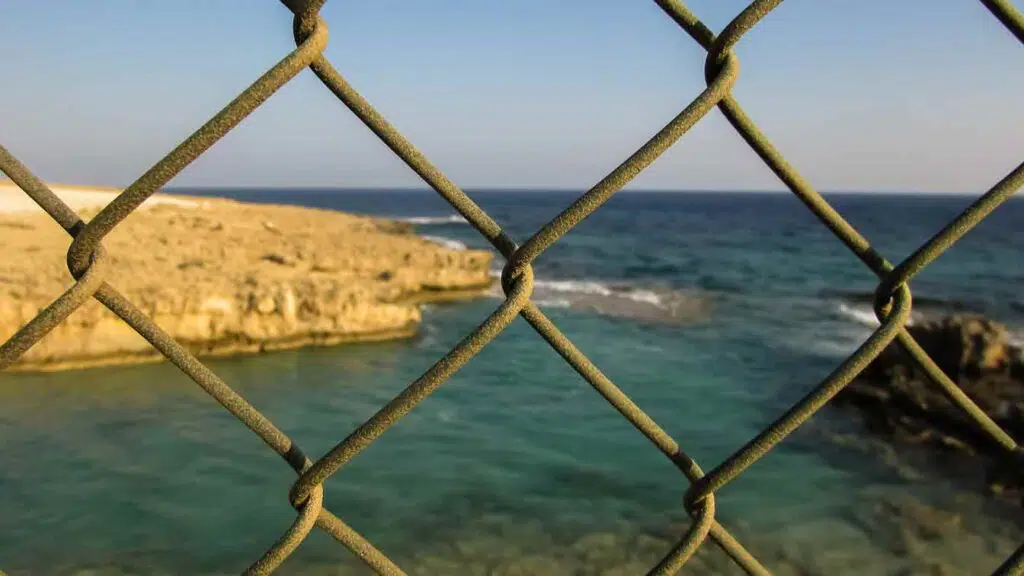 a fence at a private beach