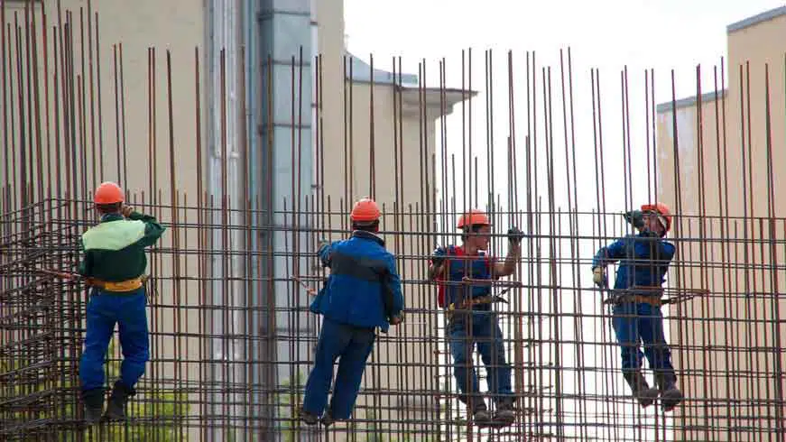 construction workers building with steel