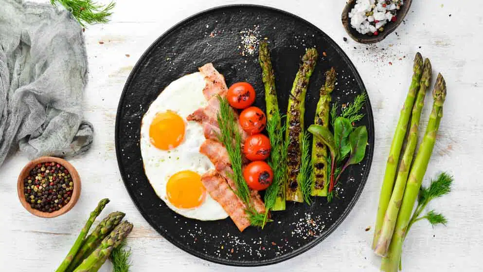 a fried breakfast with bacon and eggs
