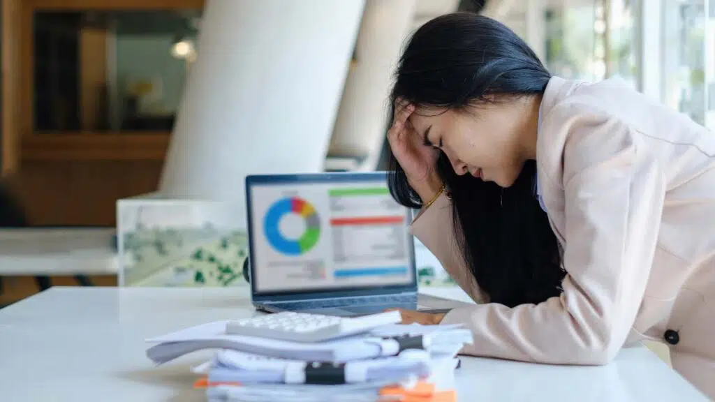 a woman feeling stressed about business