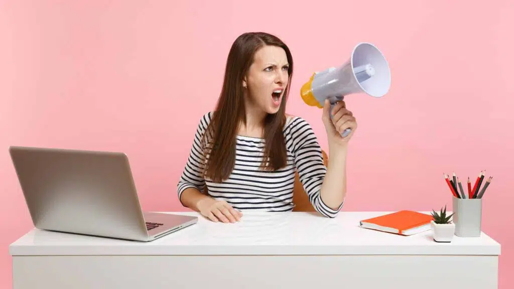 angry woman screaming into a megaphone
